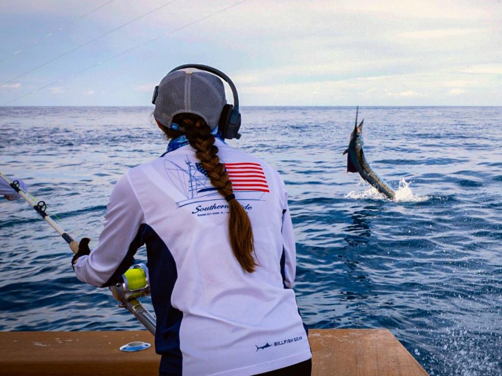 Woman reeling in sailfish